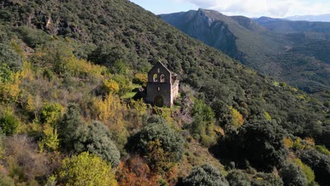 aerial view of ruined church in mountain landscape