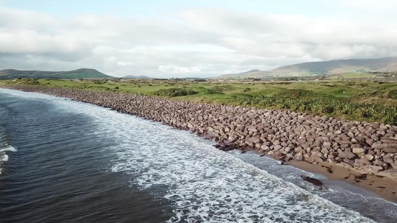 vista aérea de un hermoso paisaje en connemara, irlanda, playa con olas, montañas y prados