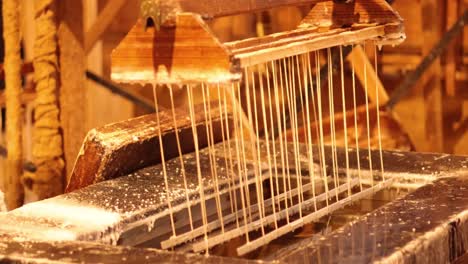 hand-dipping candles in wax at historical site