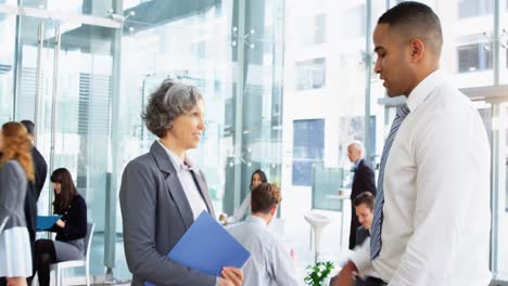 businesspeople shaking hands in office