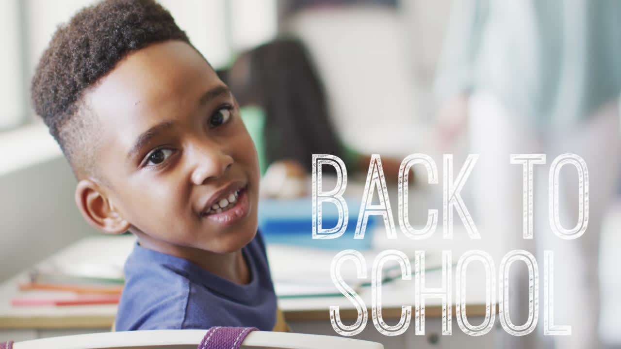 Animation of back to school text over happy african american schoolboy at school