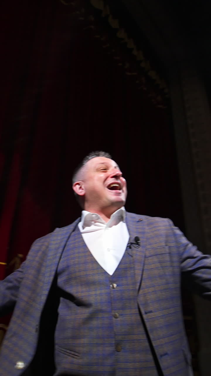 Young actor rehearsing a scene in a theater. Medium shot of an actor performing a monologue in a theater Vertical video