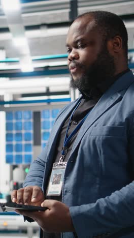 vertical video executive manager overseeing green energy production in a high tech plant