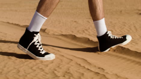 man with black sneakers walking