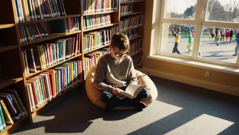 a young boy reads a book in a sunlit library or school reading corner