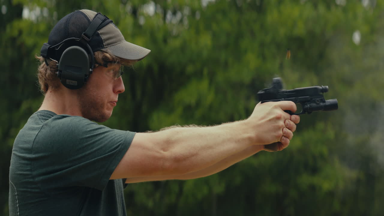 Man shooting a pistol outdoors