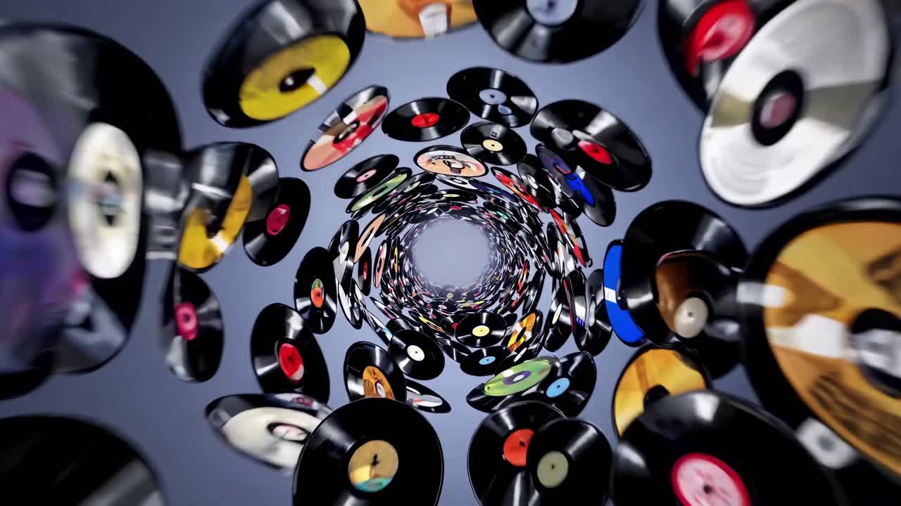 Many colorful spinning vinyl records are forming a vortex against a gray background, creating a mesmerizing visual effect that celebrates the history of music and analog audio technology