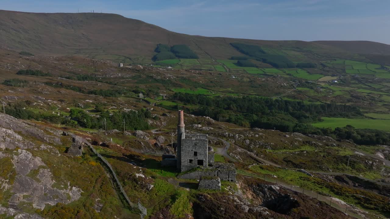 Copper Mine, Allihies, County Cork, Ireland, September 2024. Drone orbits counter clockwise around the historic ruined structure surrounded by the rugged mountainous landscape.