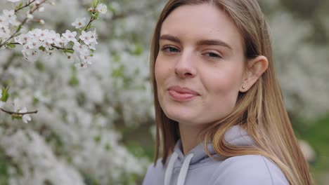 woman in a park surrounded by spring flowers
