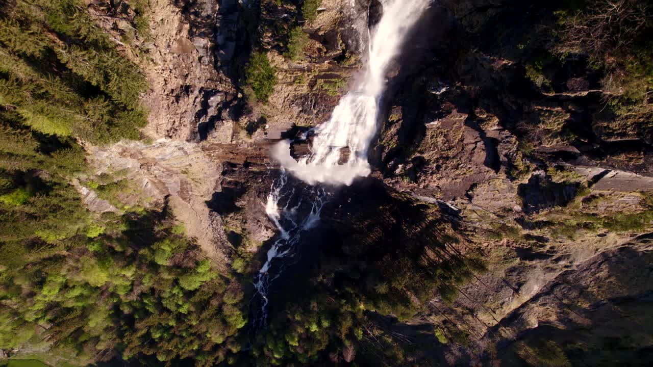 imágenes aéreas de drones empujando con vistas de arriba hacia abajo de una hermosa cascada en grindelwald en los alpes suizos
