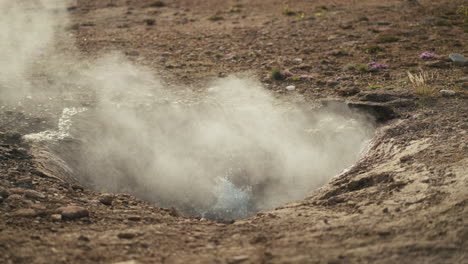 geyser eruption: steam rising from geothermal hot spring