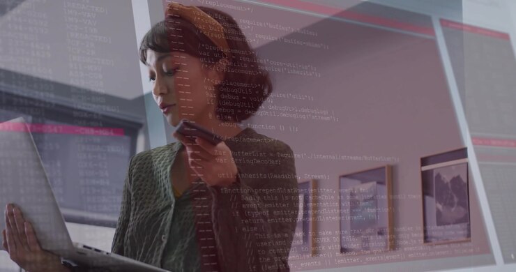 IT pro holding laptop and raising smartphone speaking activating red code overlay for data analysis