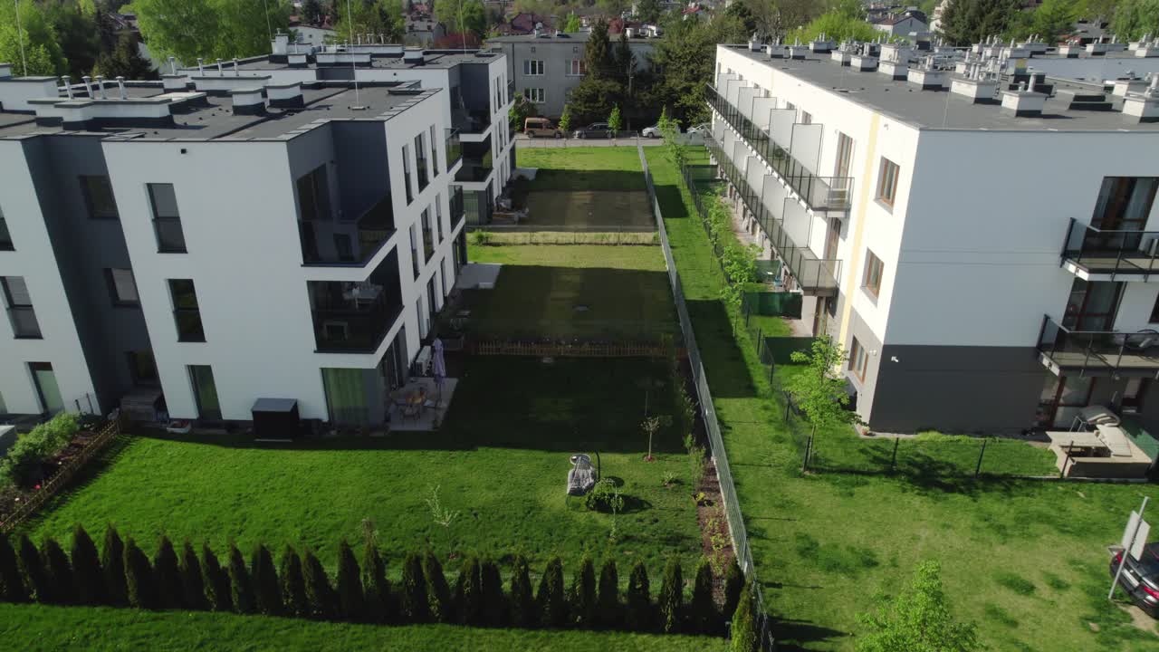 Aerial View of Modern Apartment Buildings with Green Lawns