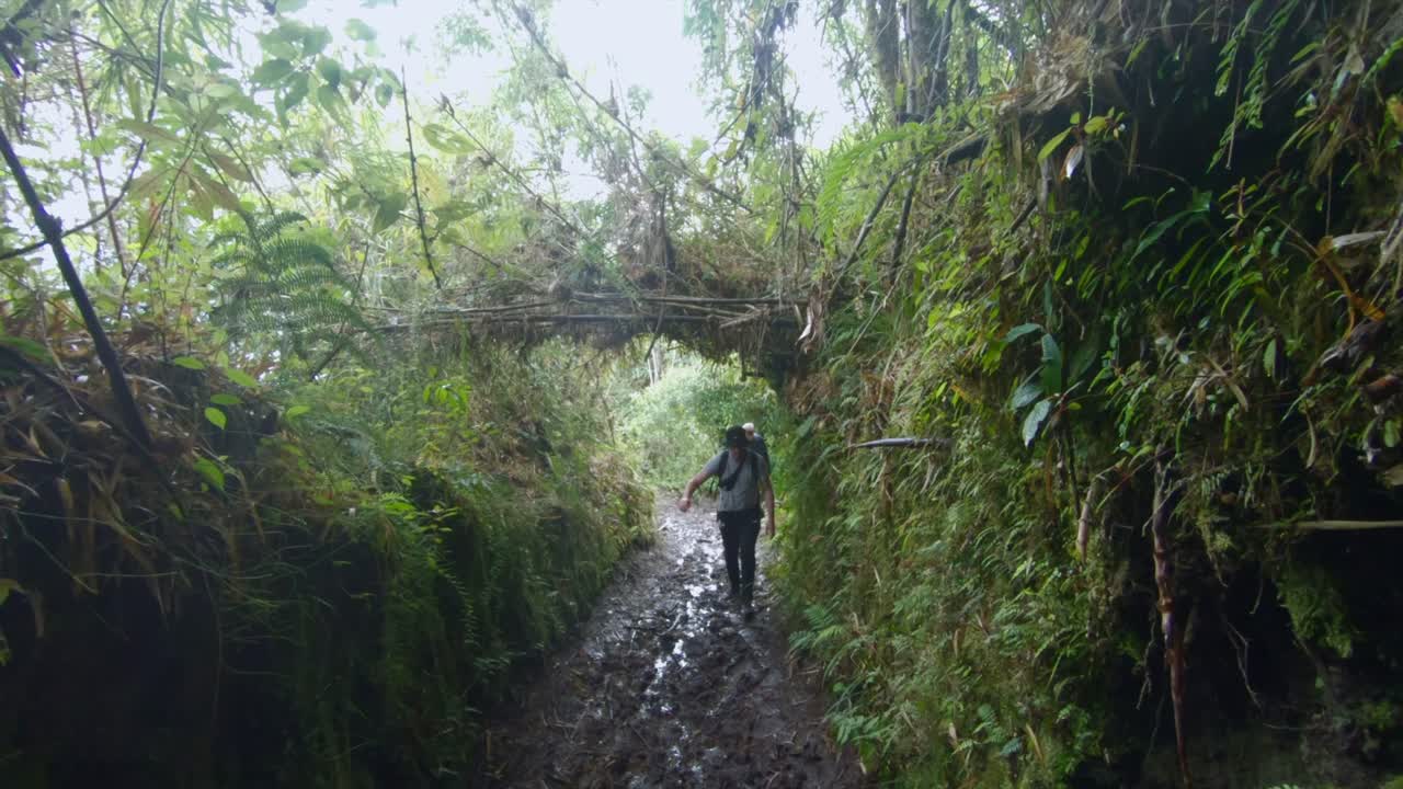 Hiking mud path humid trail wet pond trip excursion to Tungurahua volcano Ecuador
