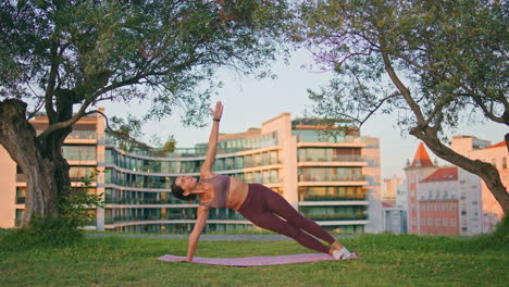 fitness woman training body core at rubber mat outdoors. lady planking exercise