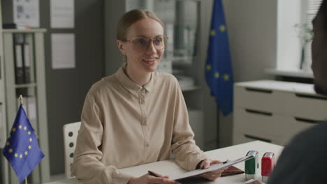 visa officer conducting immigration interview with applicant at eu embassy