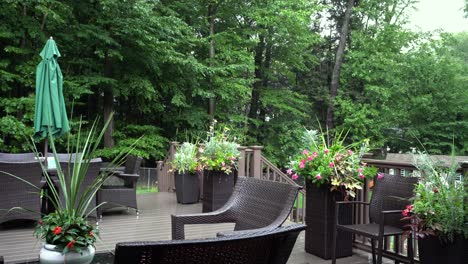 rain lightly pattering on a suburban deck during a summer storm