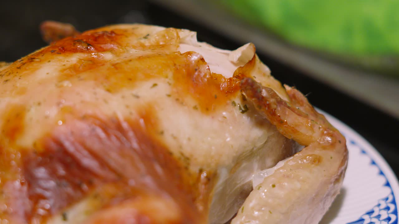 Overview of Cooked Roast Chicken with Crispy Skin with Wings and Legs Ready to Carve to Feed Family and Friends. Traditional British Sunday Dinner Feast 4K.