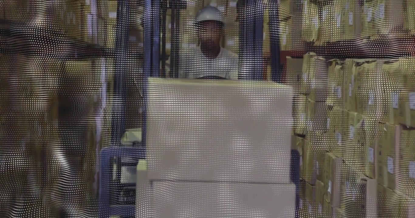 Forklift operator engaging controls and driving loaded pallet down warehouse aisle for restocking