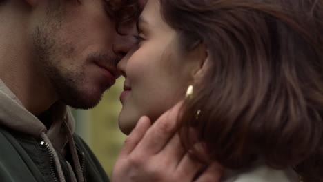 happy couple spending date outdoor. affectionate man touching woman face.