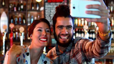 couple taking selfie on mobile phone