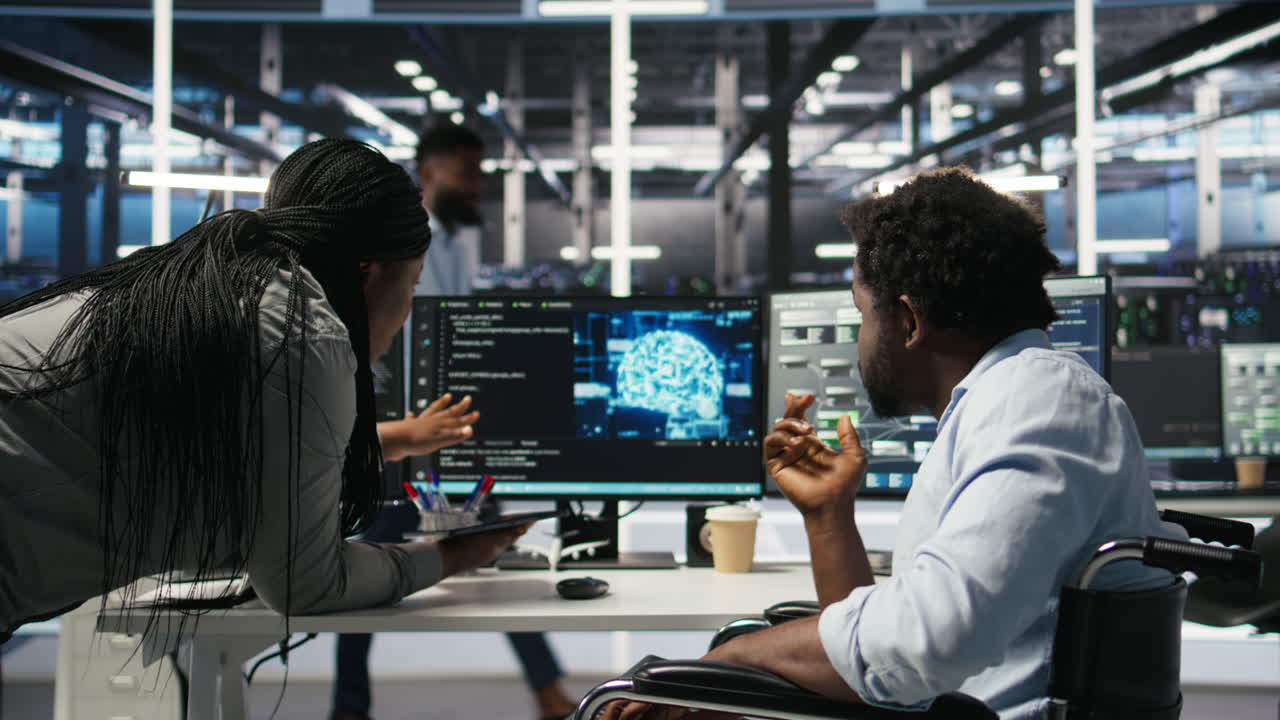 Data center engineer in wheelchair and colleague oversee AI automated tasks