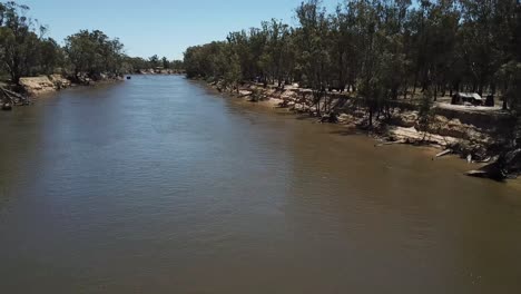 drone aerial over a muddy river in australia camping outback