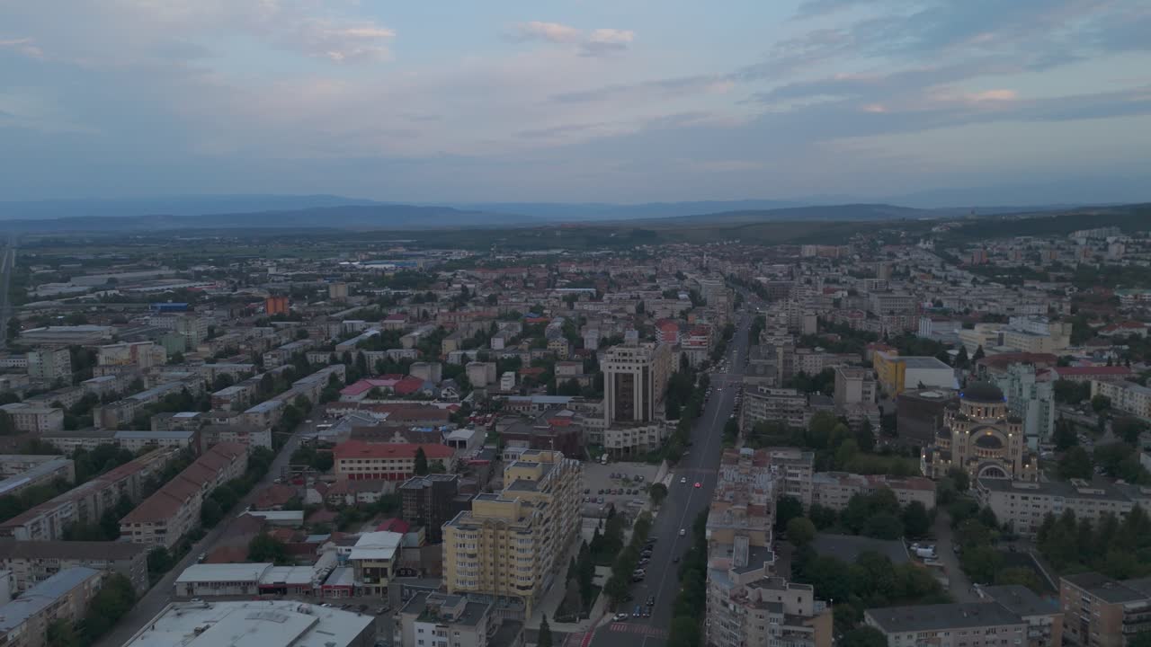 Aerial twilight view of Deva, capturing soft evening colors and the city’s urban landscape