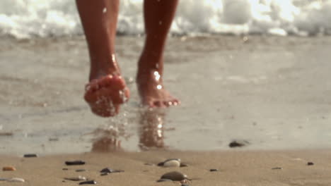 female feet walking out of water