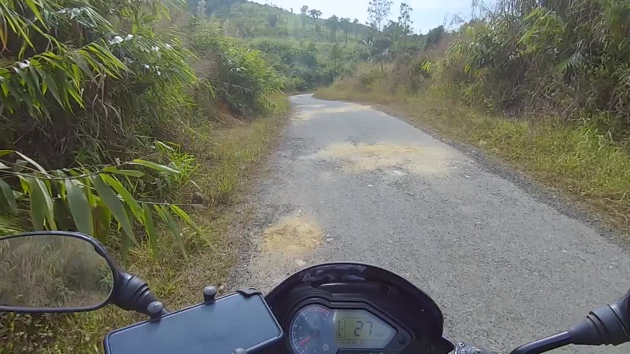 motociclista montando bicicleta en los bosques senderos en el día desde un ángulo plano