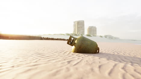 old rusted metal gas tank on the beach