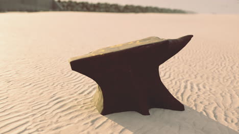 unique black anvil resting on sunlit sandy shore at midday