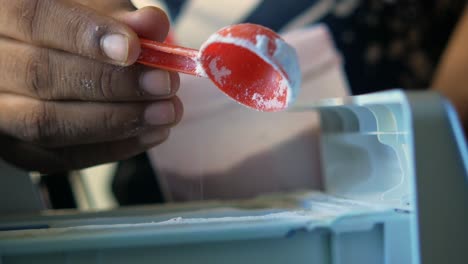 Adding Laundry Detergent to Washing Machine