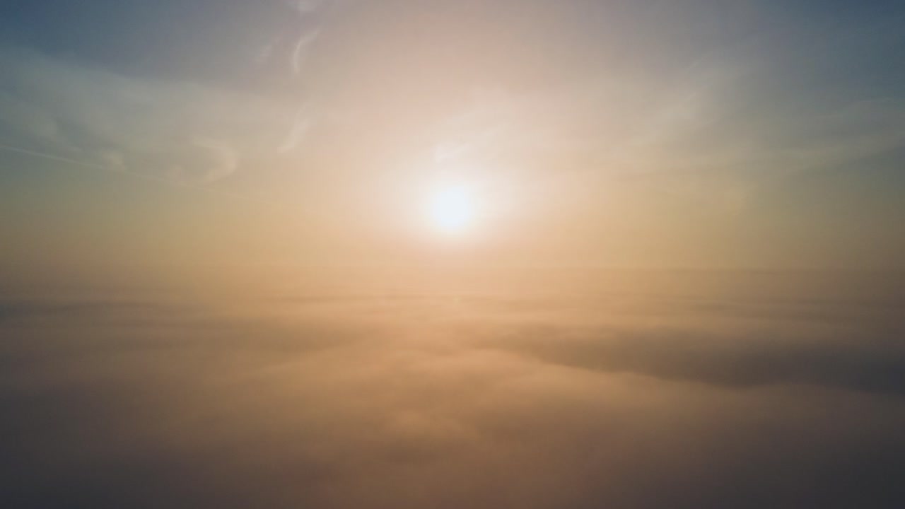 Aerial drone shot of atmospheric sunrise above the clouds