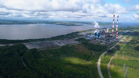 aerial view of a power plant by a lake