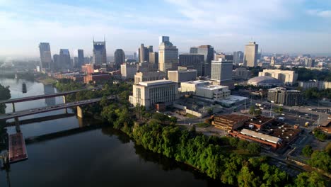 fast aerial push into nashville tennessee skyline over cumberland river