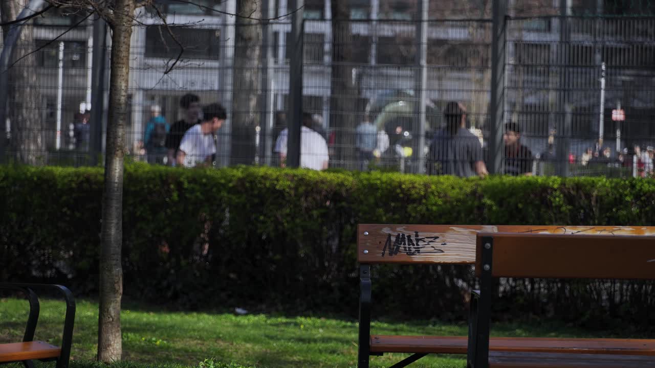 Boys are having fun playing basketball on the street in Vienna, Austria