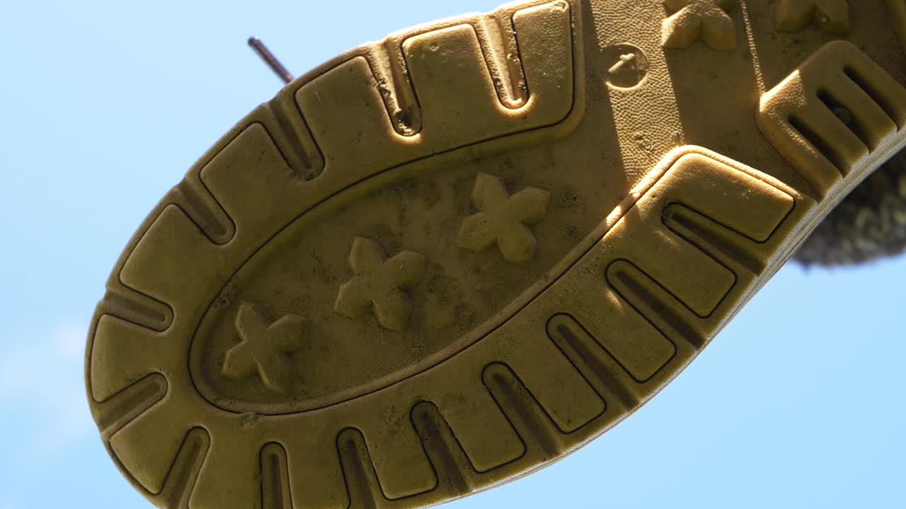 Sole of boot coming down towards camera close up shot