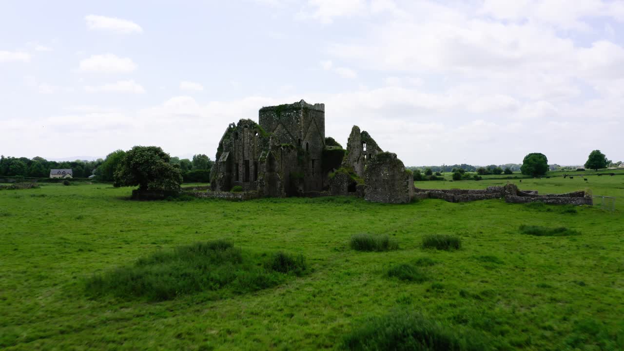 Drone shot pulling away from castle ruins.
