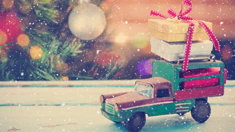 model car with presents and blurred background of a christmas tree combined with falling snow