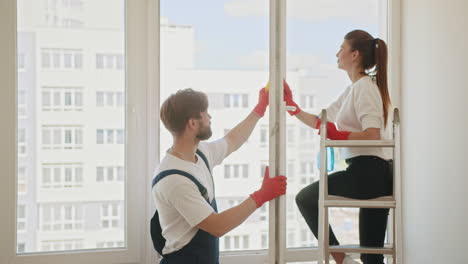 couple cleaning windows