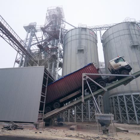 large grain storage. old truck on the background of the elevator