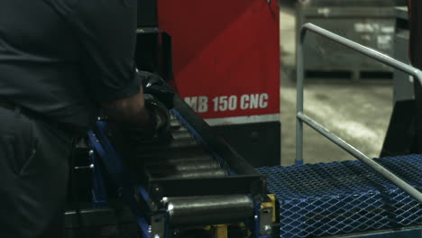 skilled laborer cleans pipe segments coming off the assembly line stabilized slider shot