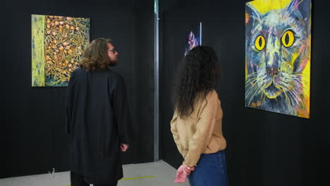 people viewing abstract art at an exhibition