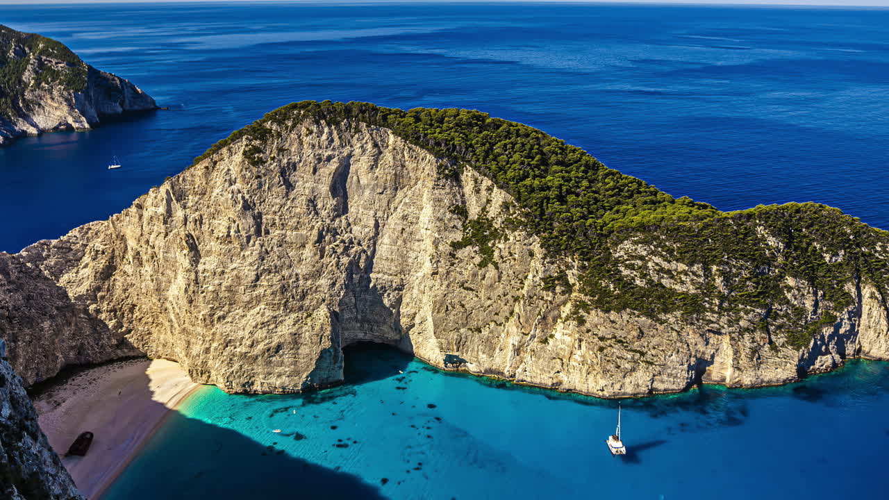 Aerial timelapse of tropical Shipwreck Beach with boats on turquoise water, Greece