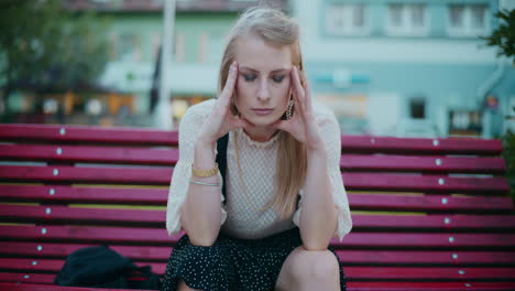 woman sitting on a bench looking stressed