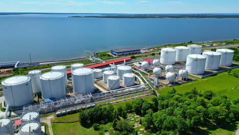 LNG-gas-depot-tanks-at-harbor-in-Estonia,-aerial-establisher-sunny-day