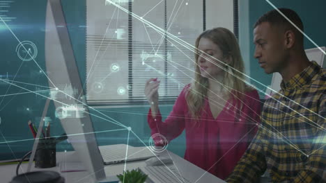 business professionals working at desk with data analytics animation overlay