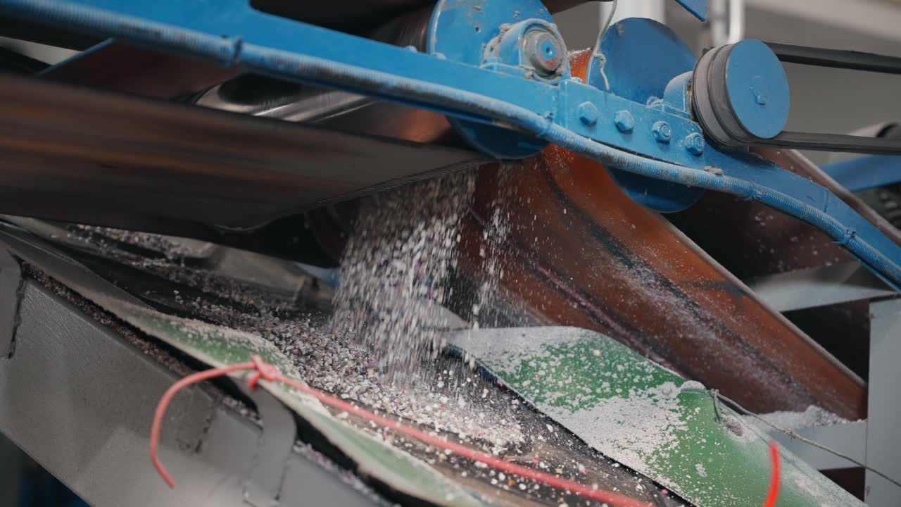 재활용 중 컨베이어에서 떨어지는 가공된 고무 과립