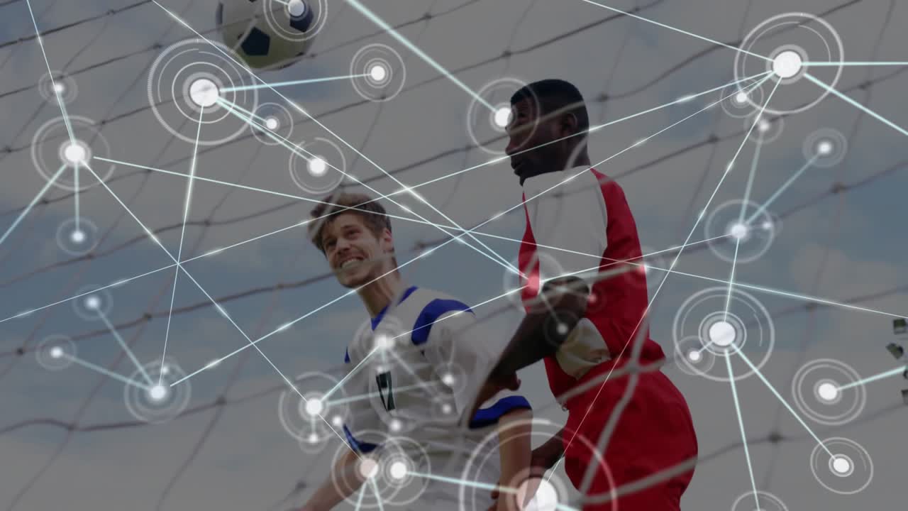 Two male soccer players jockeying for header near goal, ball causing jump, node overlay growing